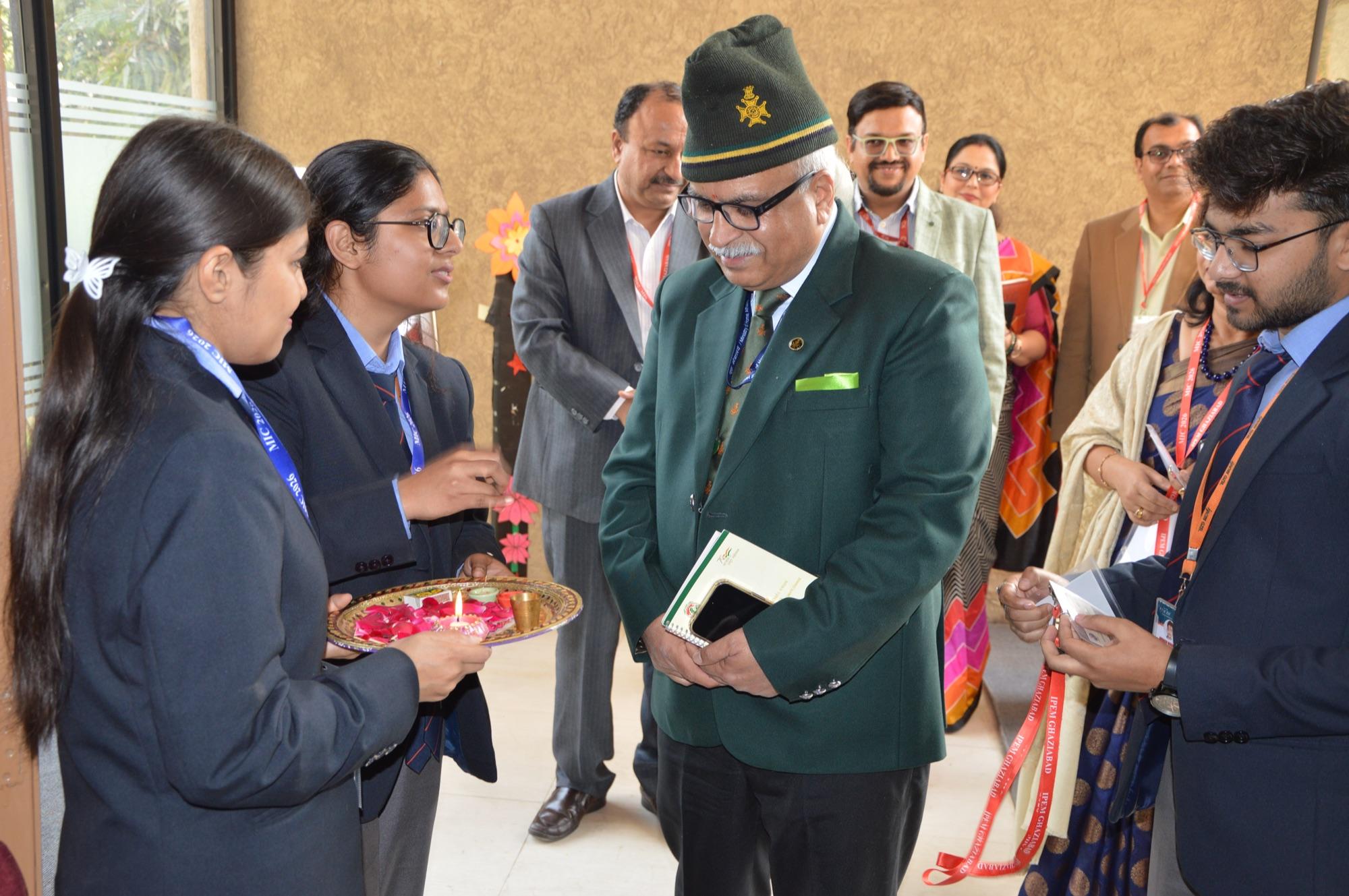 Student volunteers welcome the chief guest with rose petals on arrival.