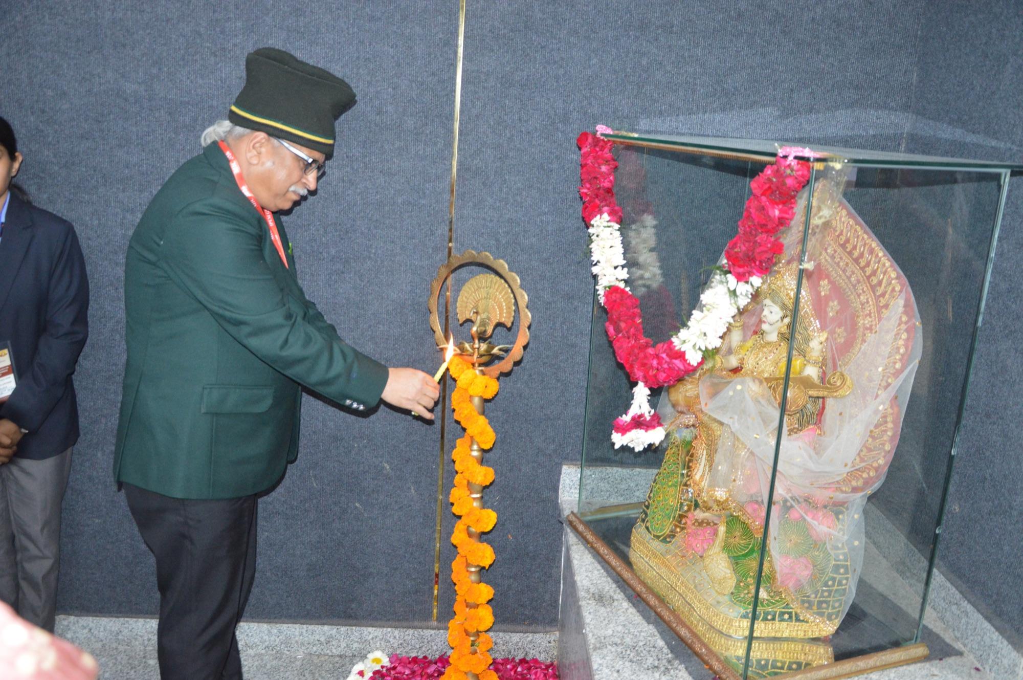 The chief guest lights the ceremonial lamp to open the conference.