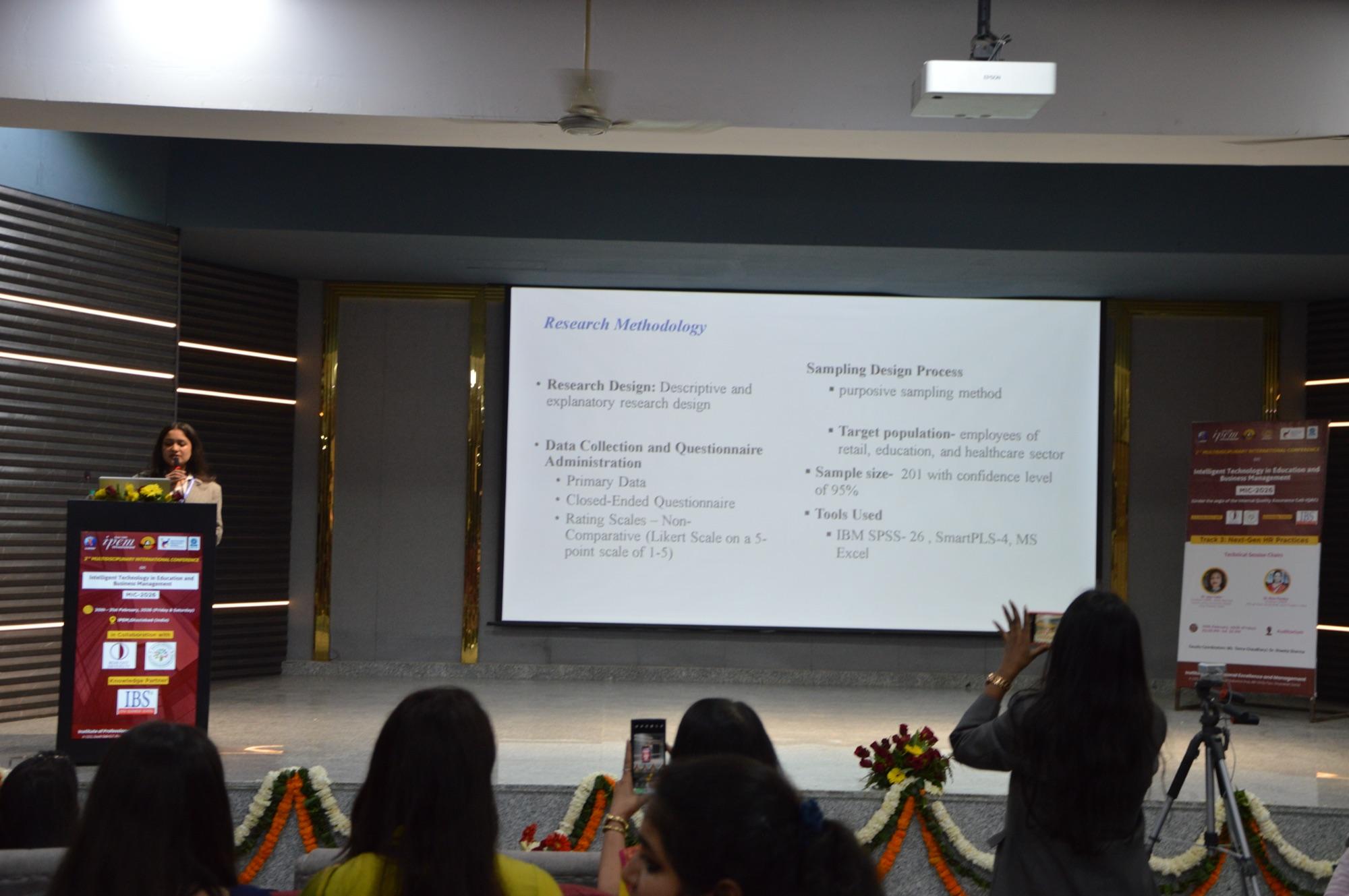 A delegate presents her research methodology to the session.